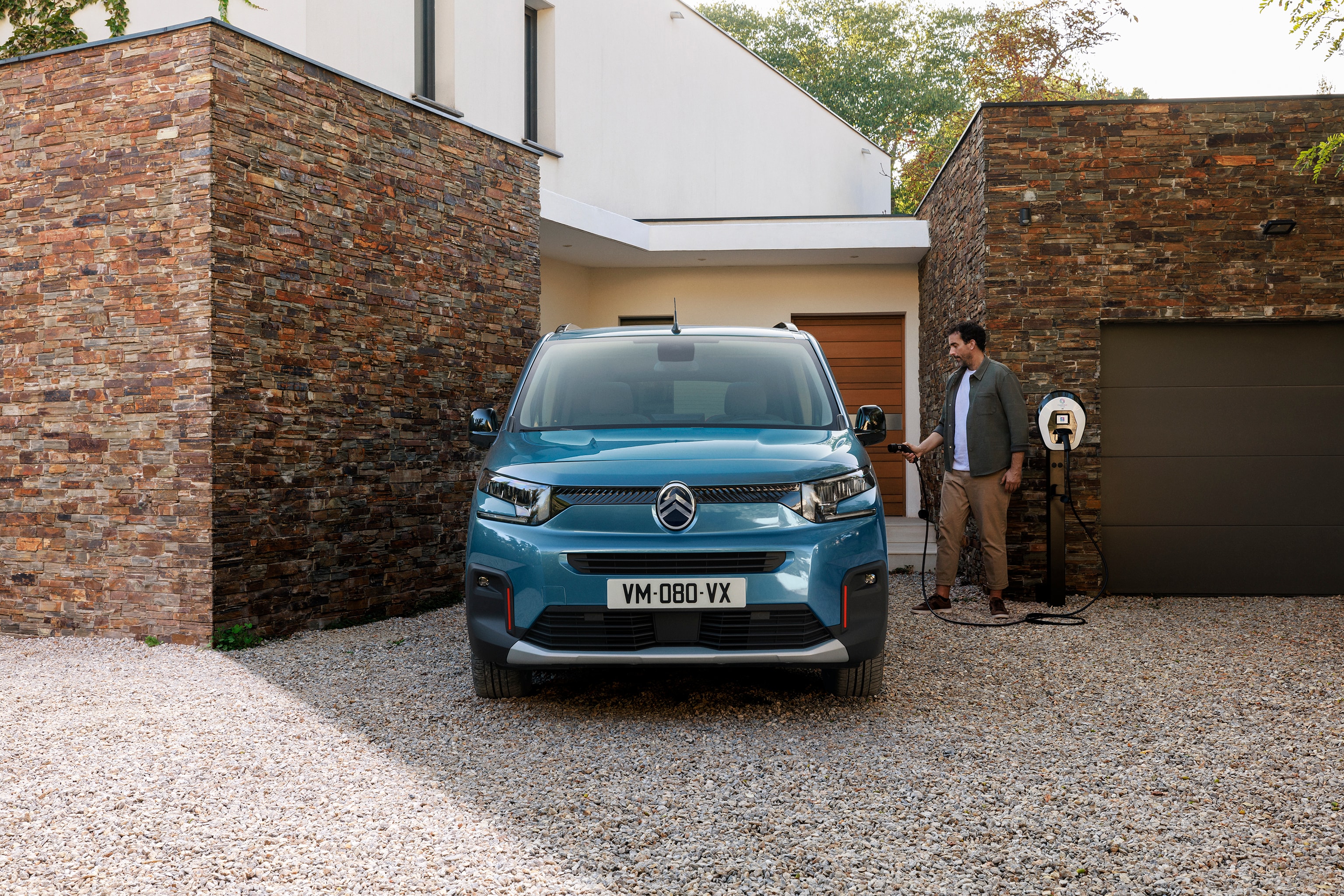 Vista frontal del ë-Berlingo mostrando carga eléctrica doméstica, seguridad, eficiencia y tecnología para fácil uso familiar diario